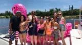 a group with a giant flamingo floatation device in west palm beach