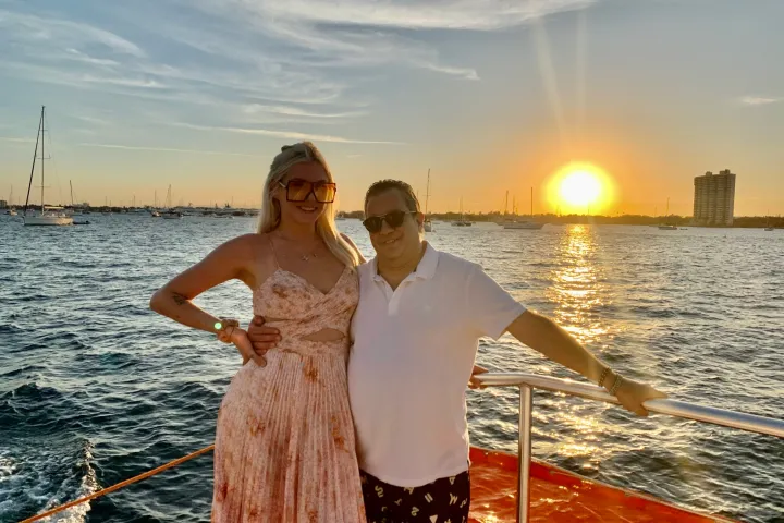 a man standing next to a body of water
