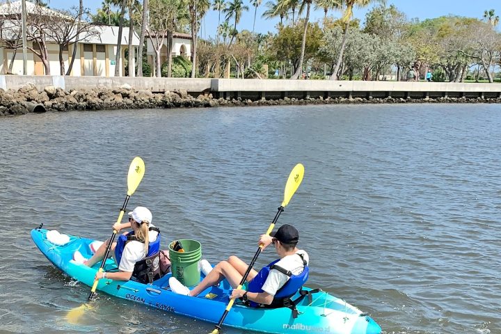 a person riding on the back of a boat in the water