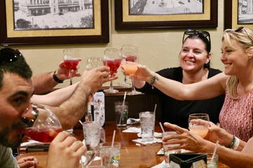 a group of people sitting at a table with wine glasses