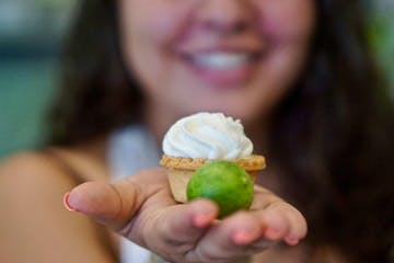 a woman holding a piece of food