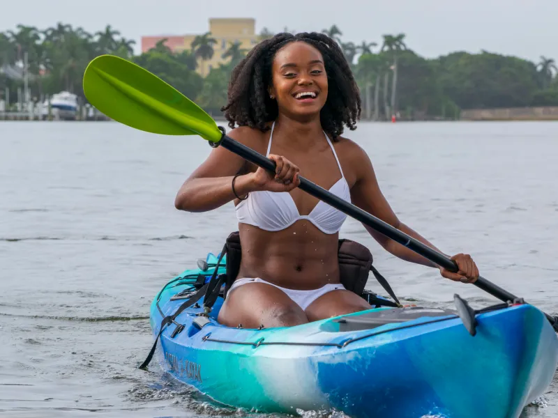 1 – Water Activities & Catamaran Cruises a person in a blue boat on a body of water