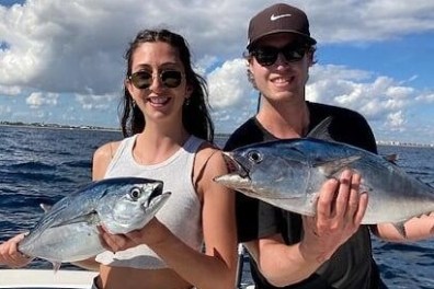 a person holding a fish in the water