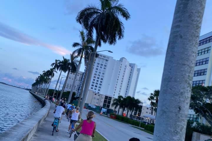 a group of people walking on a sidewalk