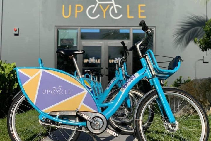 a bicycle parked in front of a blue wall