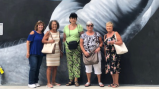 a group of people standing in front of a crowd posing for the camera