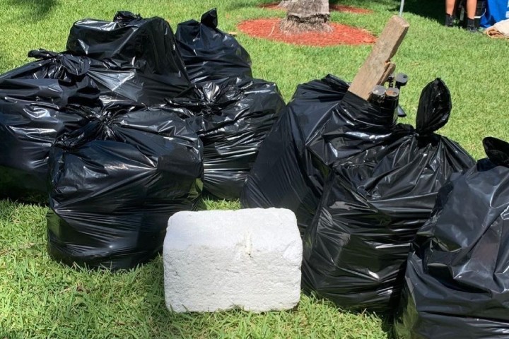 a bag of luggage sitting on top of a grass covered field