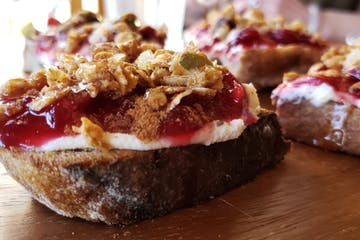 a piece of meat on a cutting board with a cake