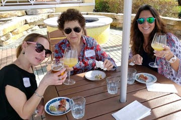 a group of people sitting at a table eating food