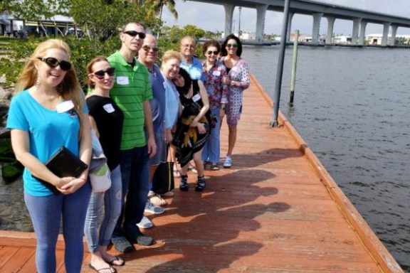 a group of people standing on a dock near the water