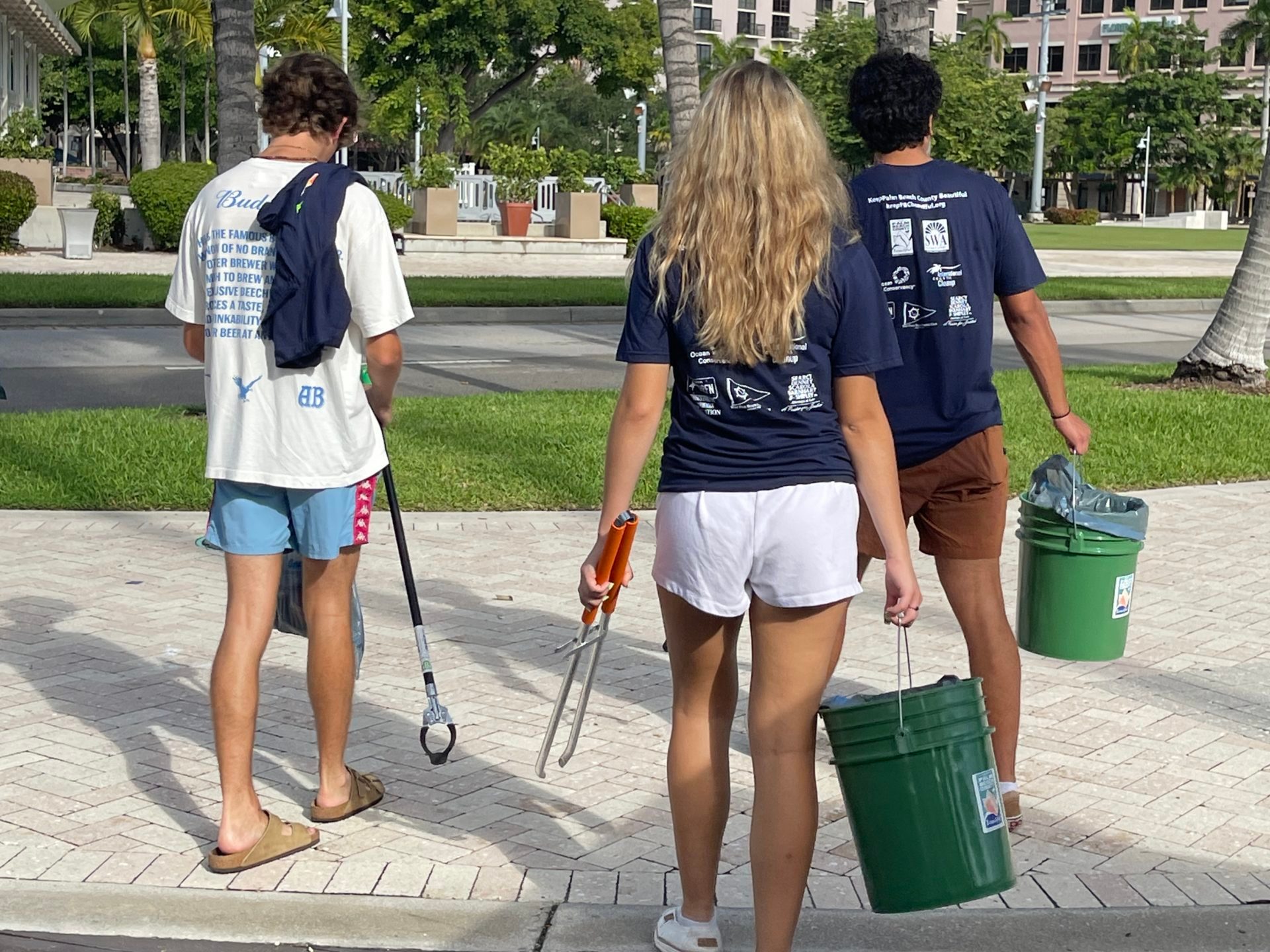 a group of people standing on a sidewalk