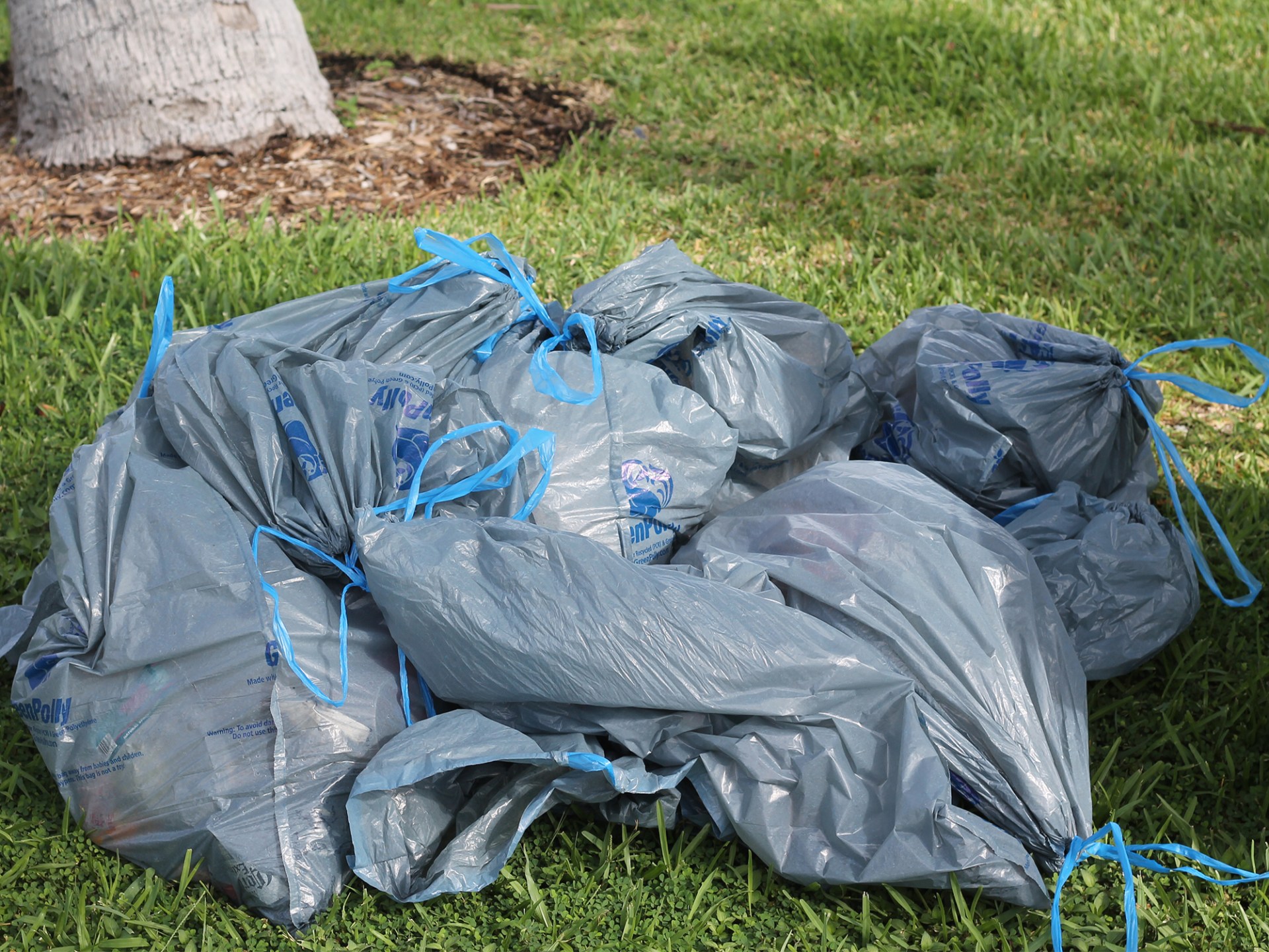 a pile of luggage sitting on top of a grass covered field