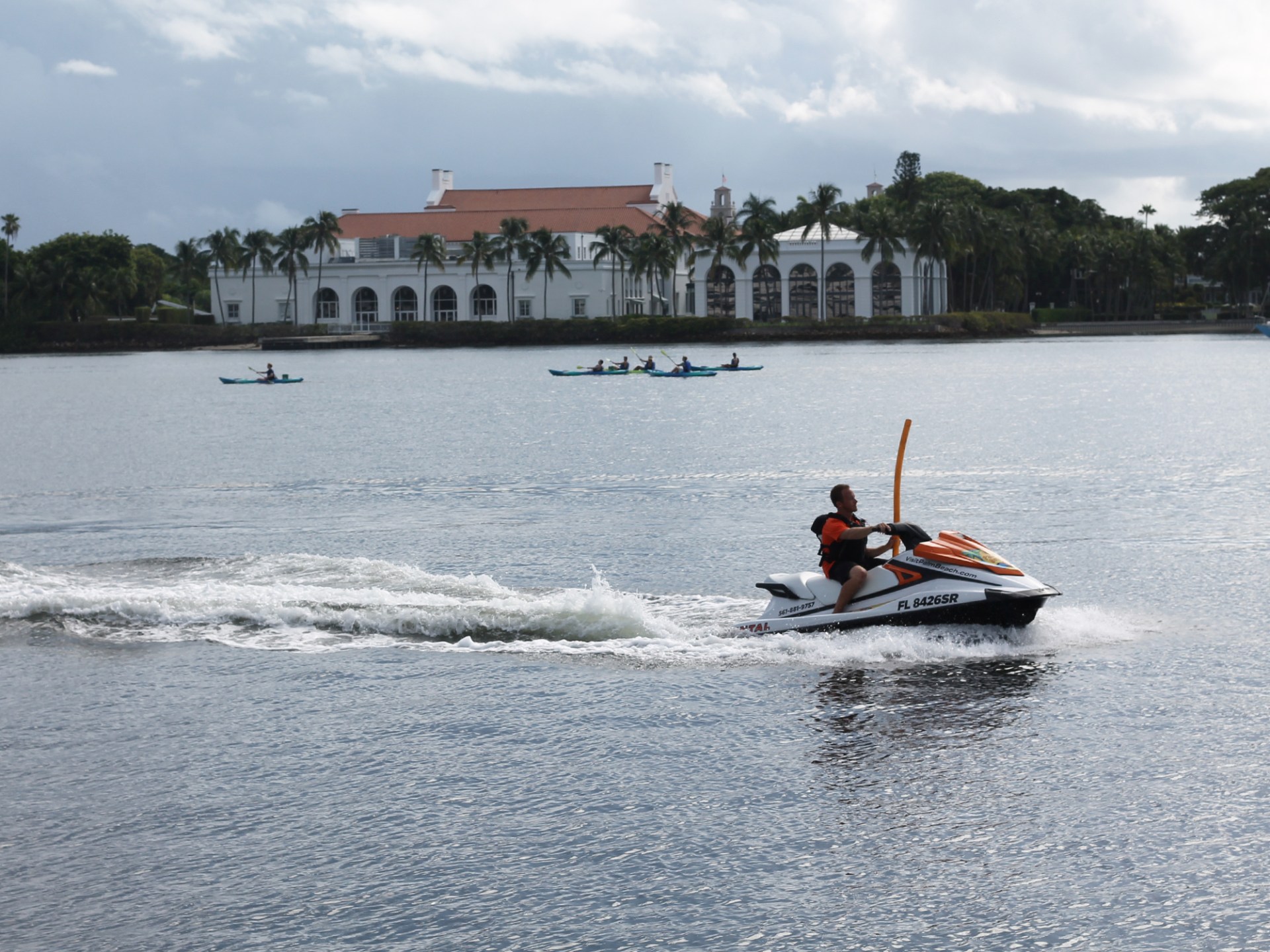 a man riding on the back of a boat in a body of water