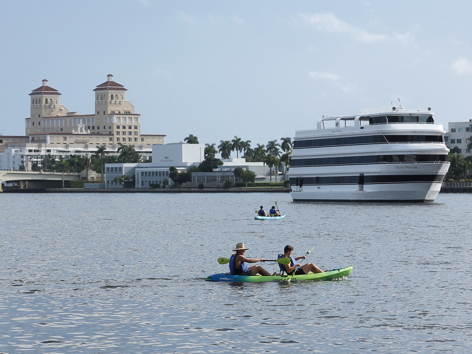 a group of people rowing a boat in a body of water