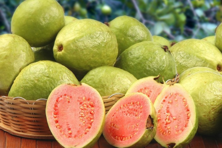 a group of fruit sitting on top of a wooden table