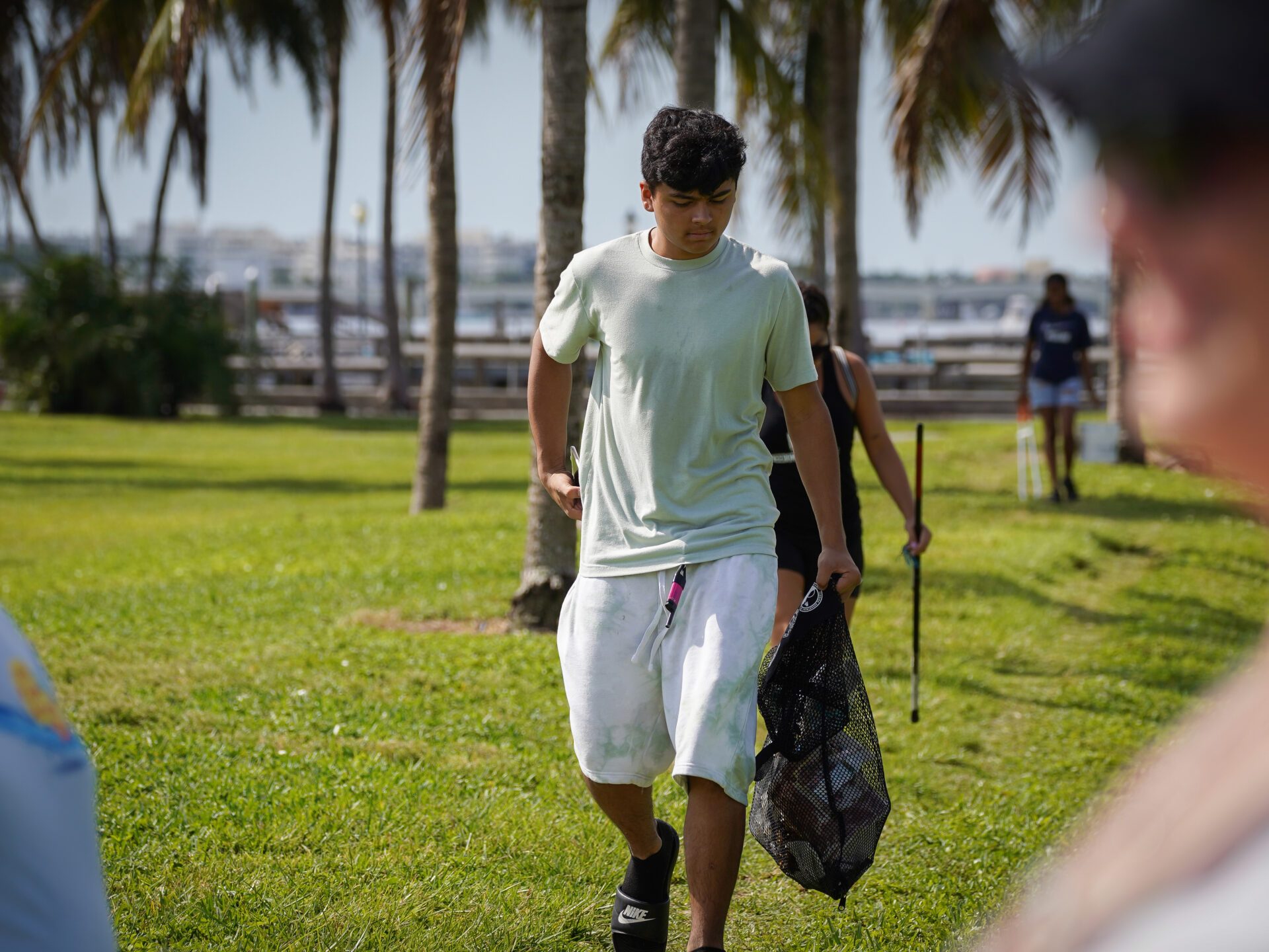 a man standing on top of a grass covered field