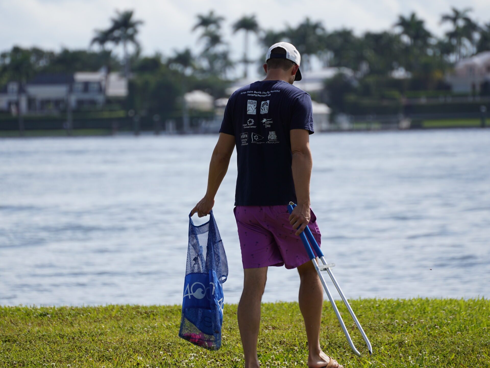 a man standing next to a body of water