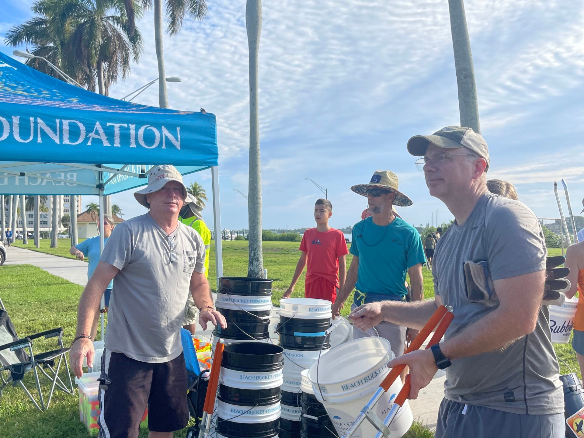a group of people standing in the grass