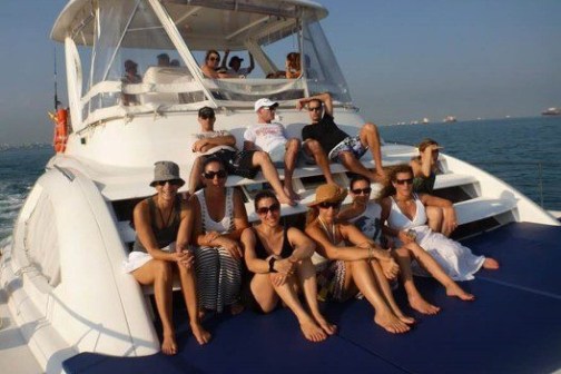 a group of people on a boat posing for the camera