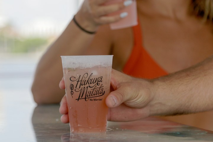 a hand holding a cup