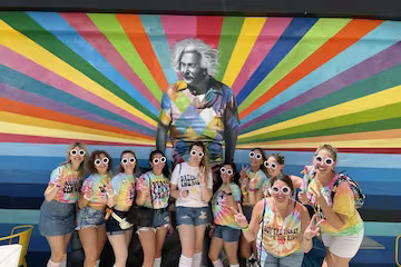 a person standing in front of a group of people posing for the camera