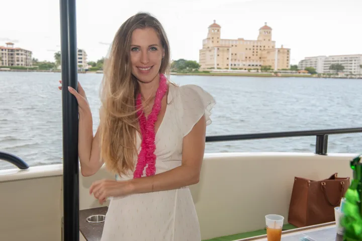 a woman standing in front of a body of water