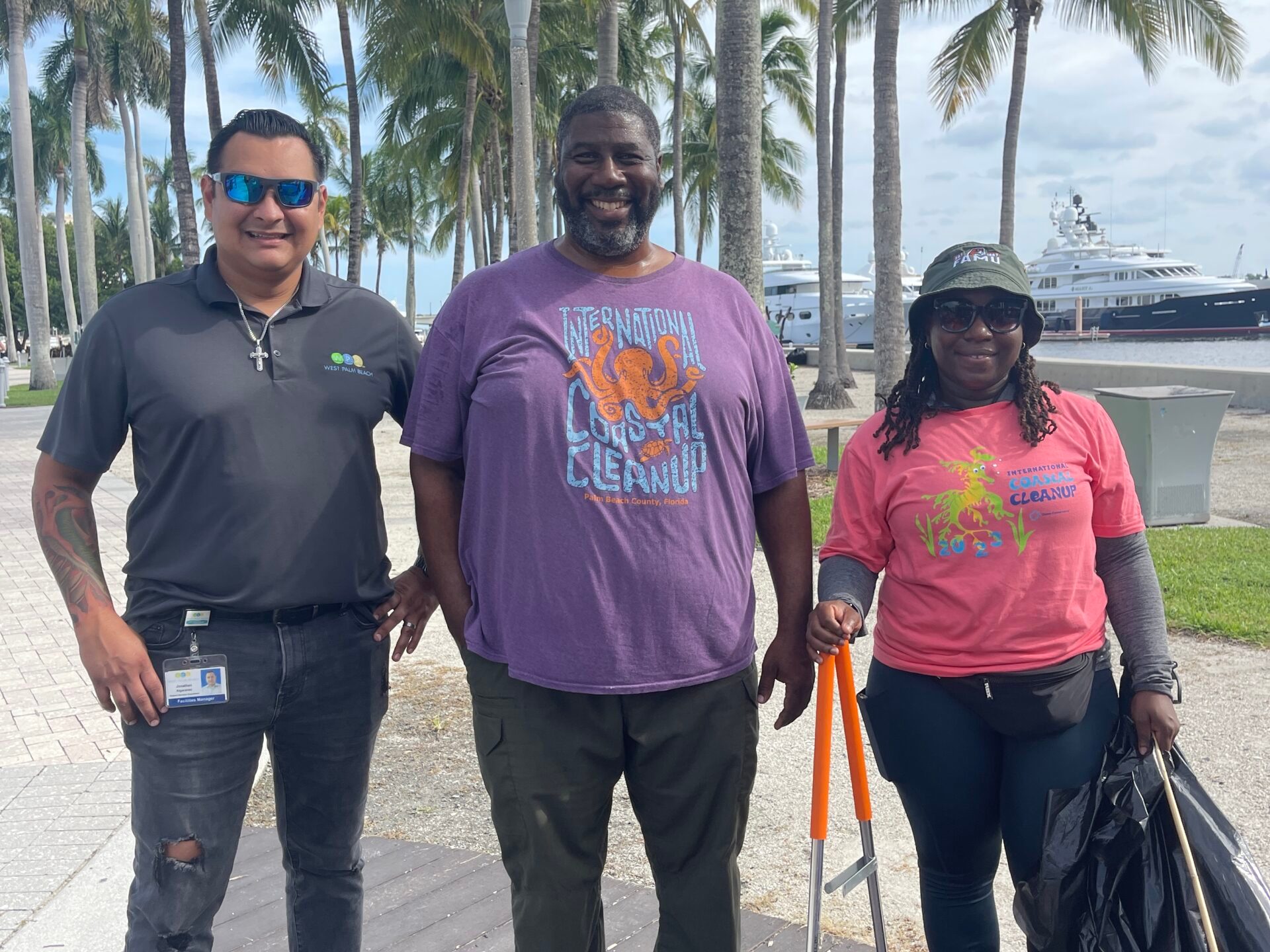 a group of people standing in front of a tree posing for the camera