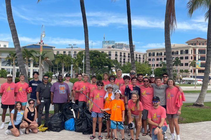 a group of people standing in front of a crowd posing for the camera