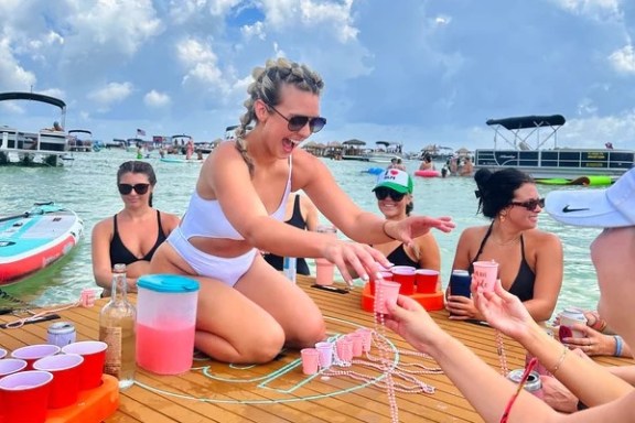 a group of people sitting at a beach
