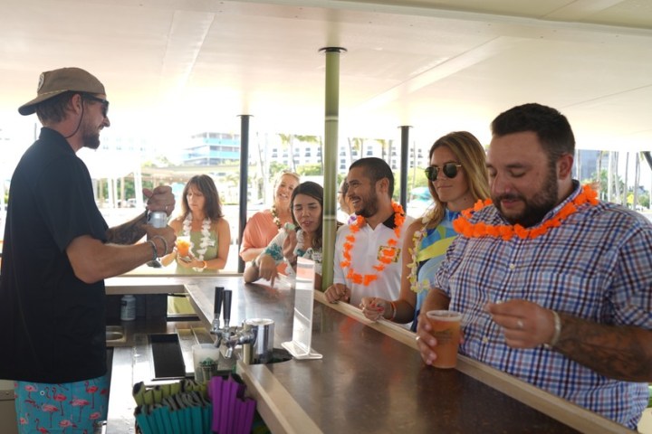a group of people standing around a table