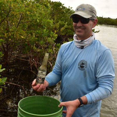 a man standing in front of a barrel