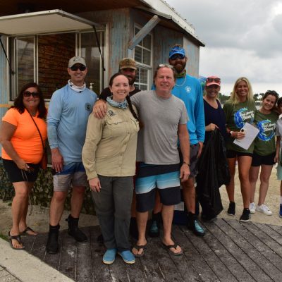 a group of people standing in front of a crowd posing for the camera