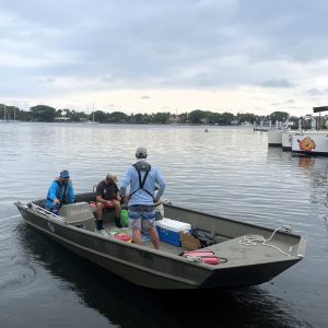 a group of people in a small boat in a body of water
