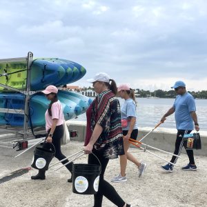a group of people standing around a plane