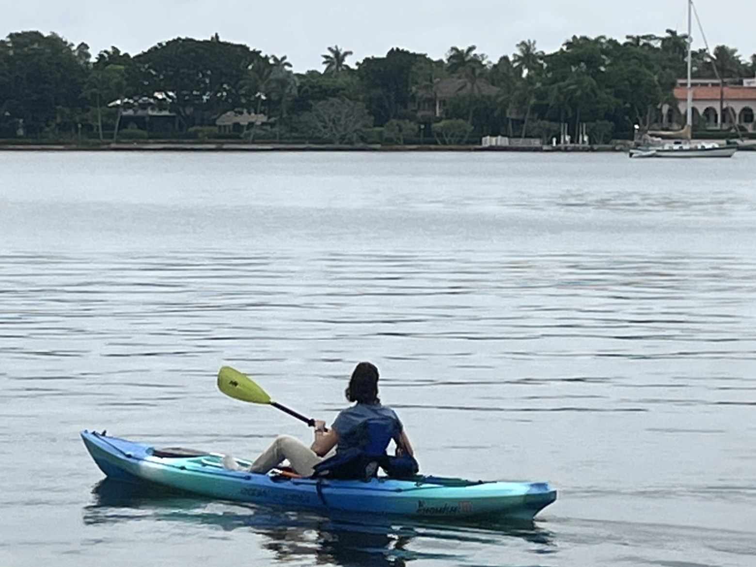 a person in a green boat on a body of water