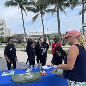 a group of people standing around a table