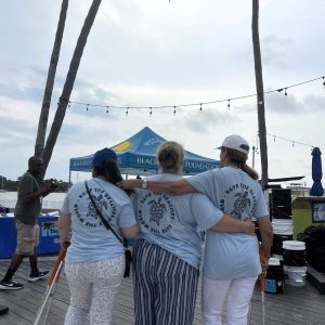 a group of people standing next to a tree