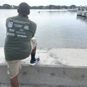 a man standing next to a body of water