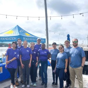 a group of people standing in front of a crowd posing for the camera
