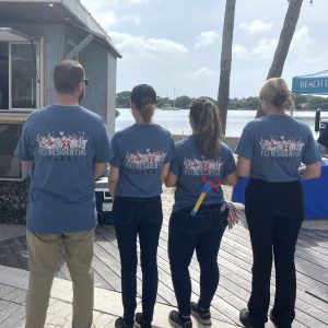 a group of people standing on a sidewalk