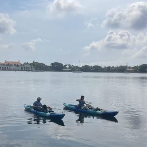 a group of people in a boat on a body of water