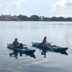 a group of people in a small boat in a body of water