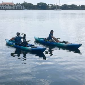 a group of people riding on the back of a boat in the water