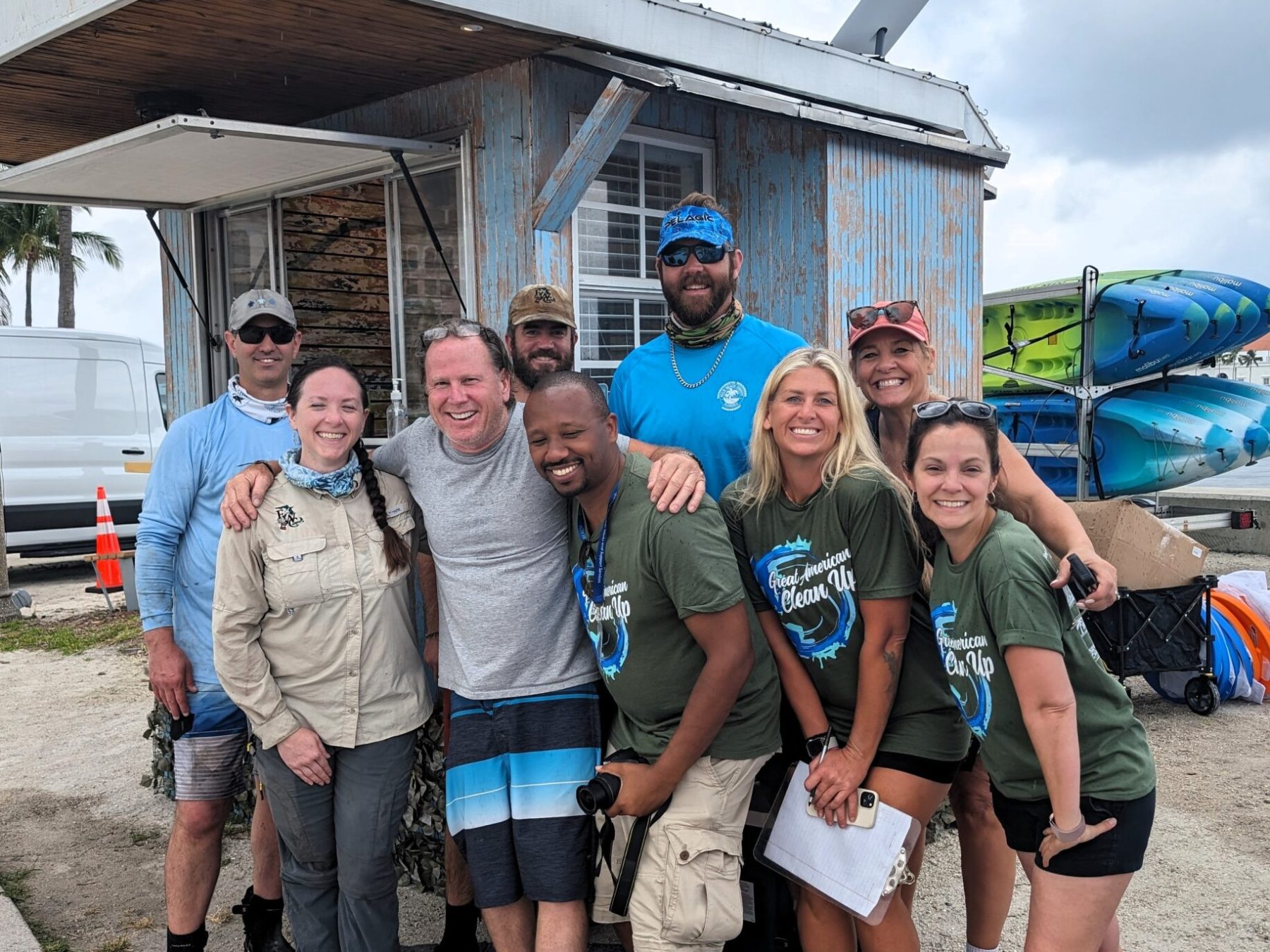 a group of people standing in front of a crowd posing for the camera