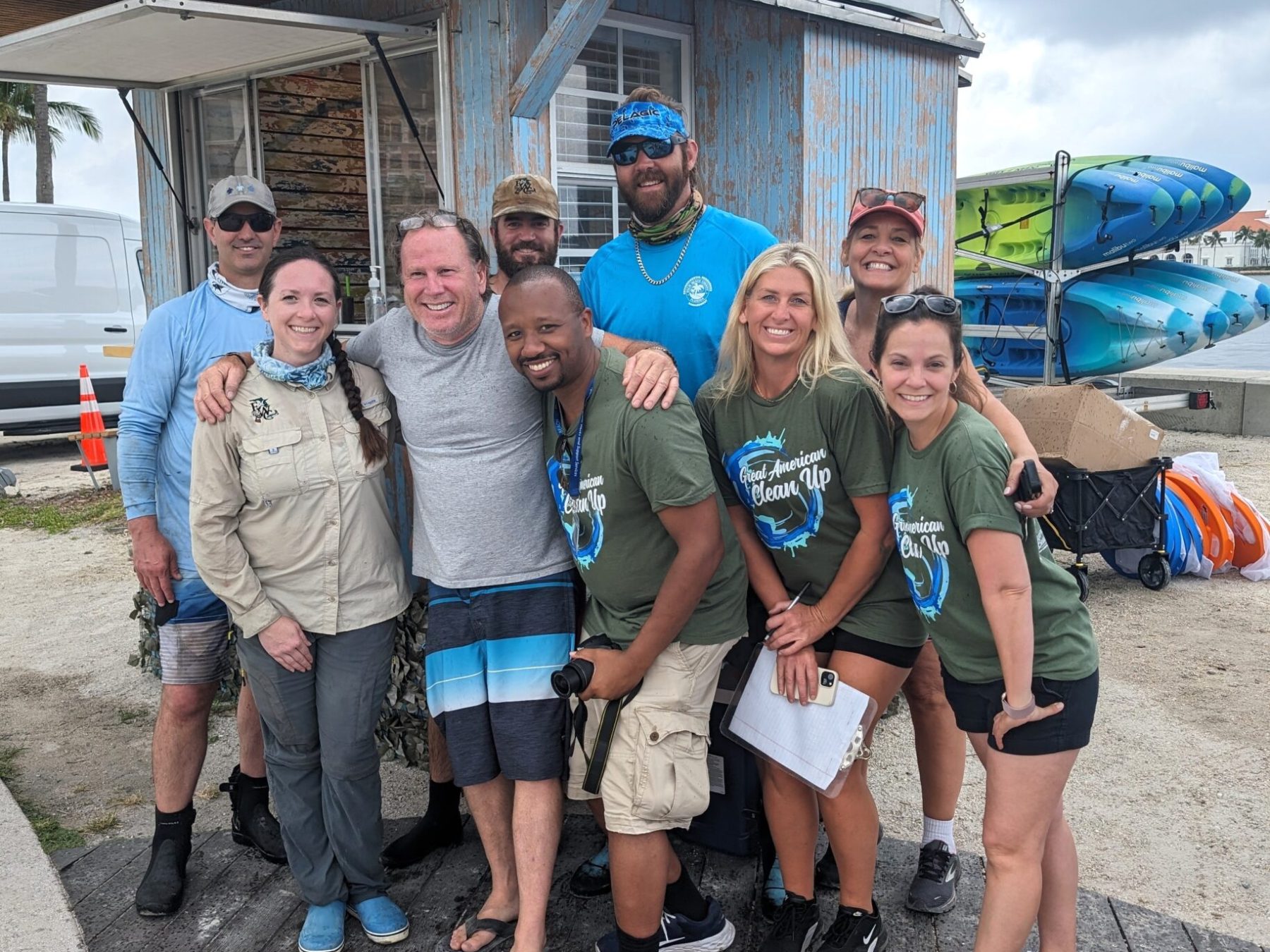 a group of people standing in front of a crowd posing for the camera