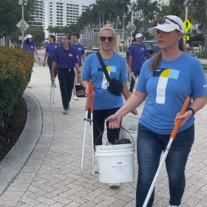 a group of people standing on a sidewalk