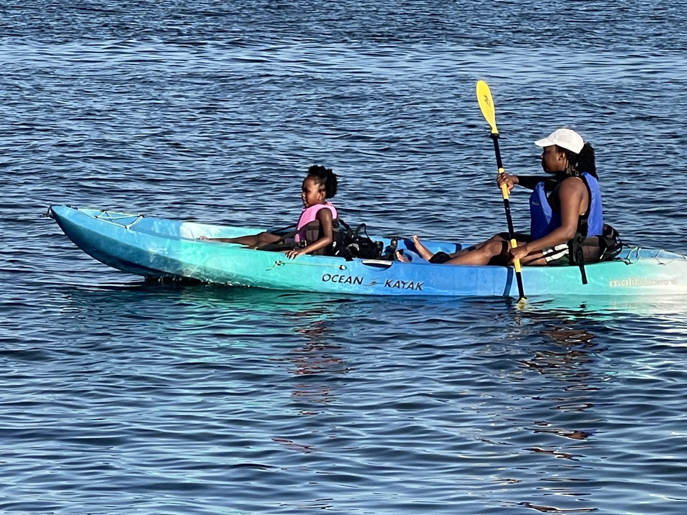 a group of people rowing a boat in the water
