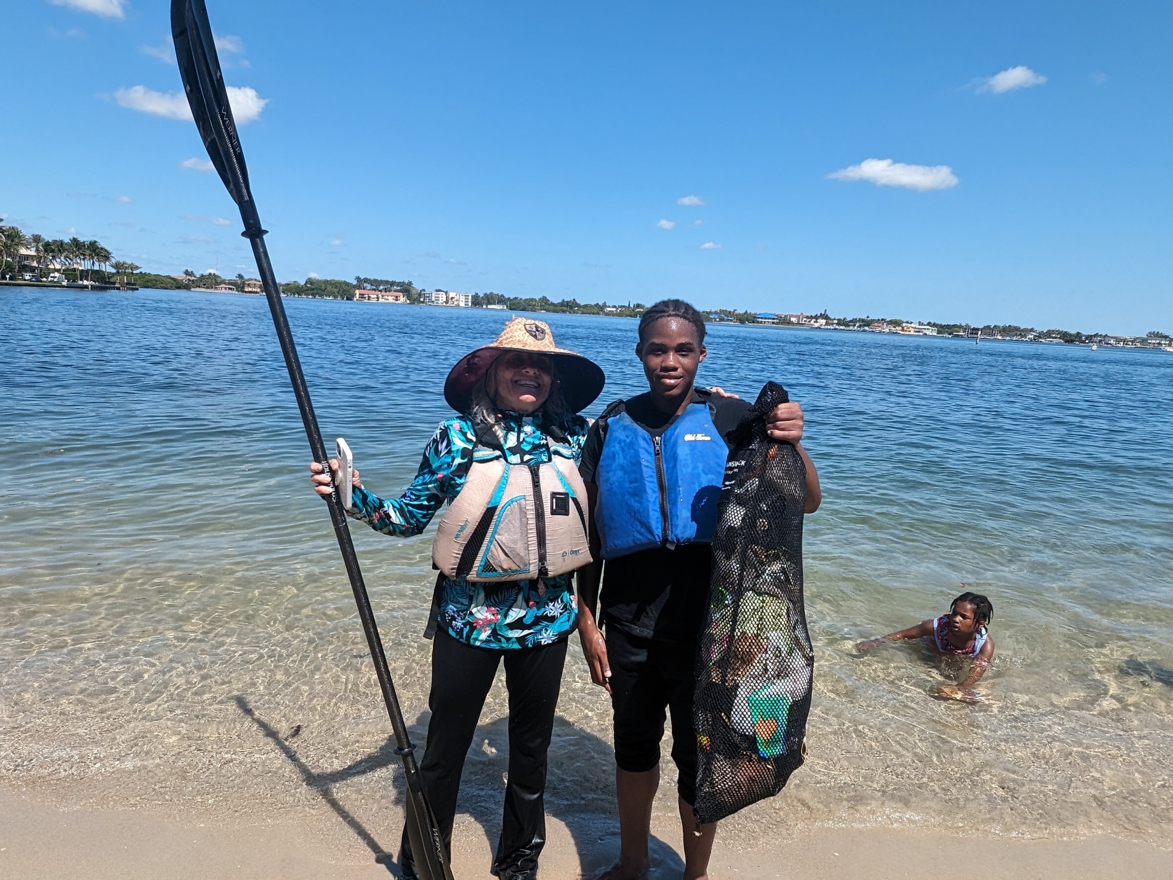 a group of people on a beach near a body of water