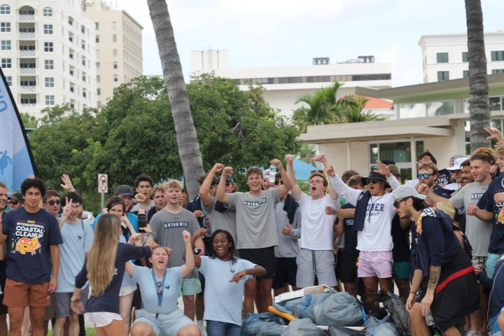 a group of people standing in front of a crowd posing for the camera