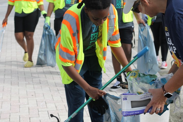 a group of people standing on top of a cutting board